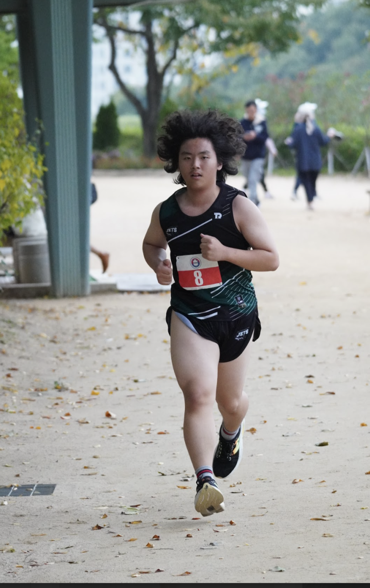  CJ Park in ninth grade starts the race strong, his hair flared out like a lion's mane.